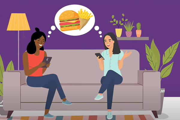 two people sit on couch with phones