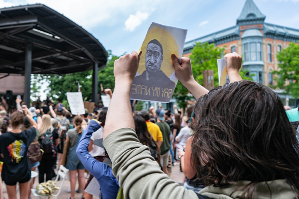 person holds up sign at protest