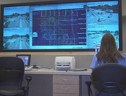 Woman sitting at desk using Advanced Traffic Management System