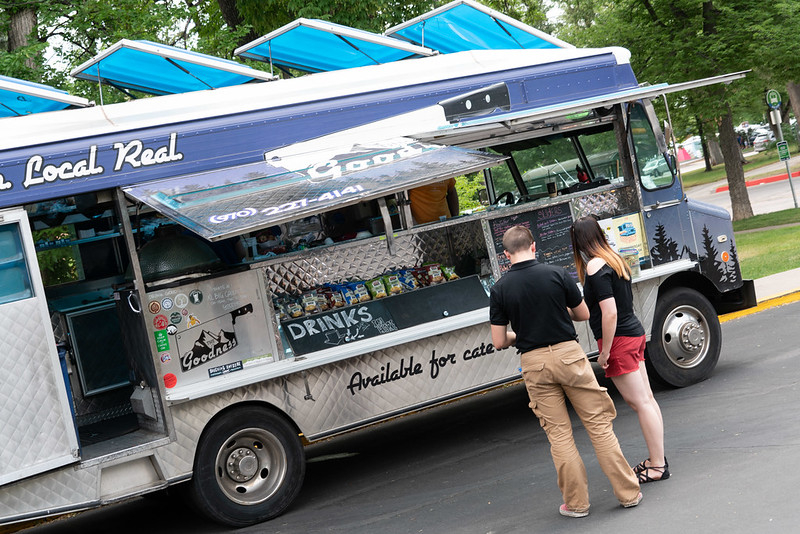 People get food from a food truck at Garden Party