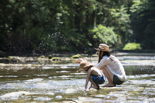 Mom and daughter playing in river