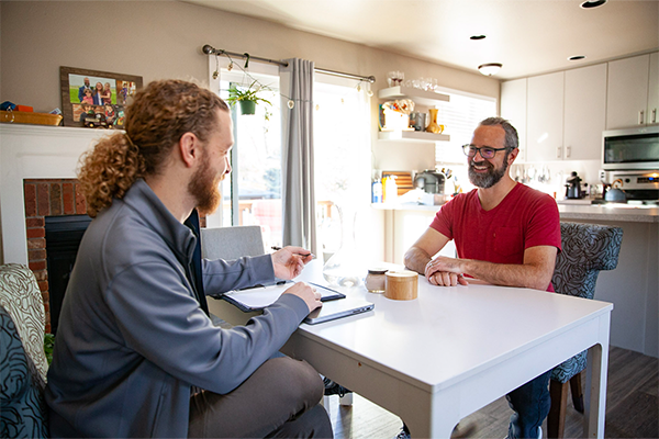 A home energy assessor talking with homeowner