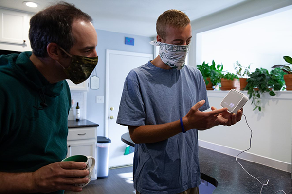 Indoor environmental quality study researcher speaking to homeowner about device