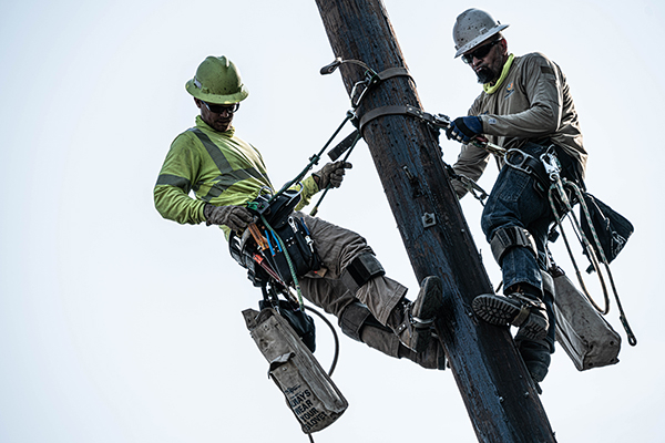 Light and Power Crew Members on Power Pole