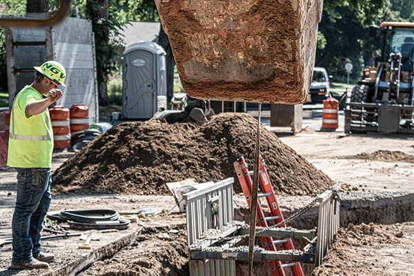 construction worker directing heavy equipment