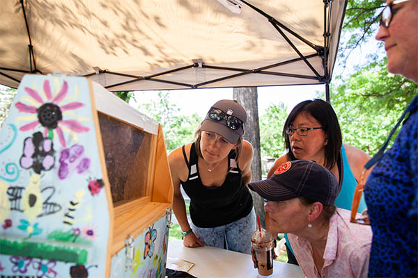 event attendees looking closely at display