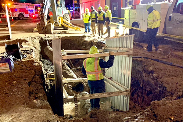 Water crew repairing water main at night