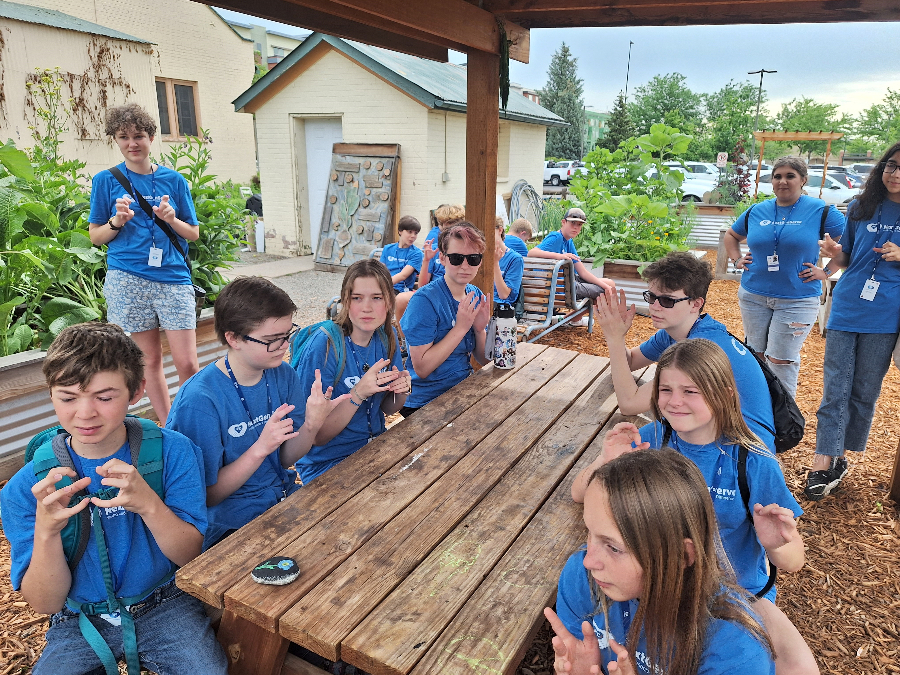 Teens at a picnic table.