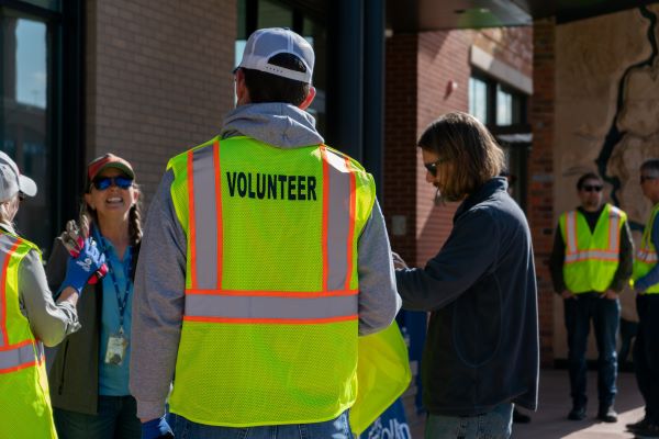 Volunteer in a safety vest during orientation for an event