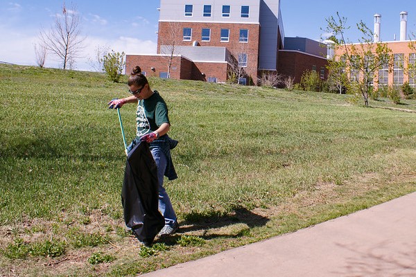 women picking up trash